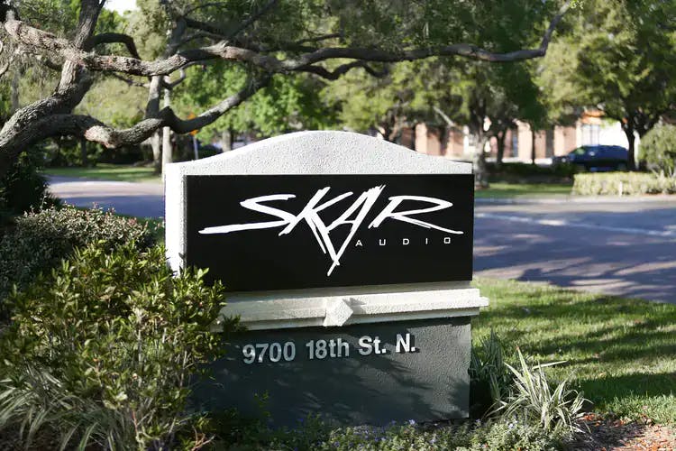 Office address sign that site outside of Skar Audio offices